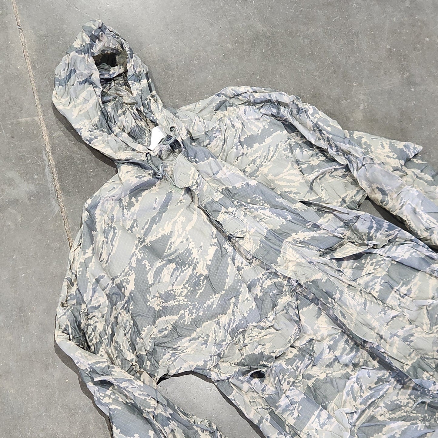 Camouflage-patterned fabric on a concrete surface