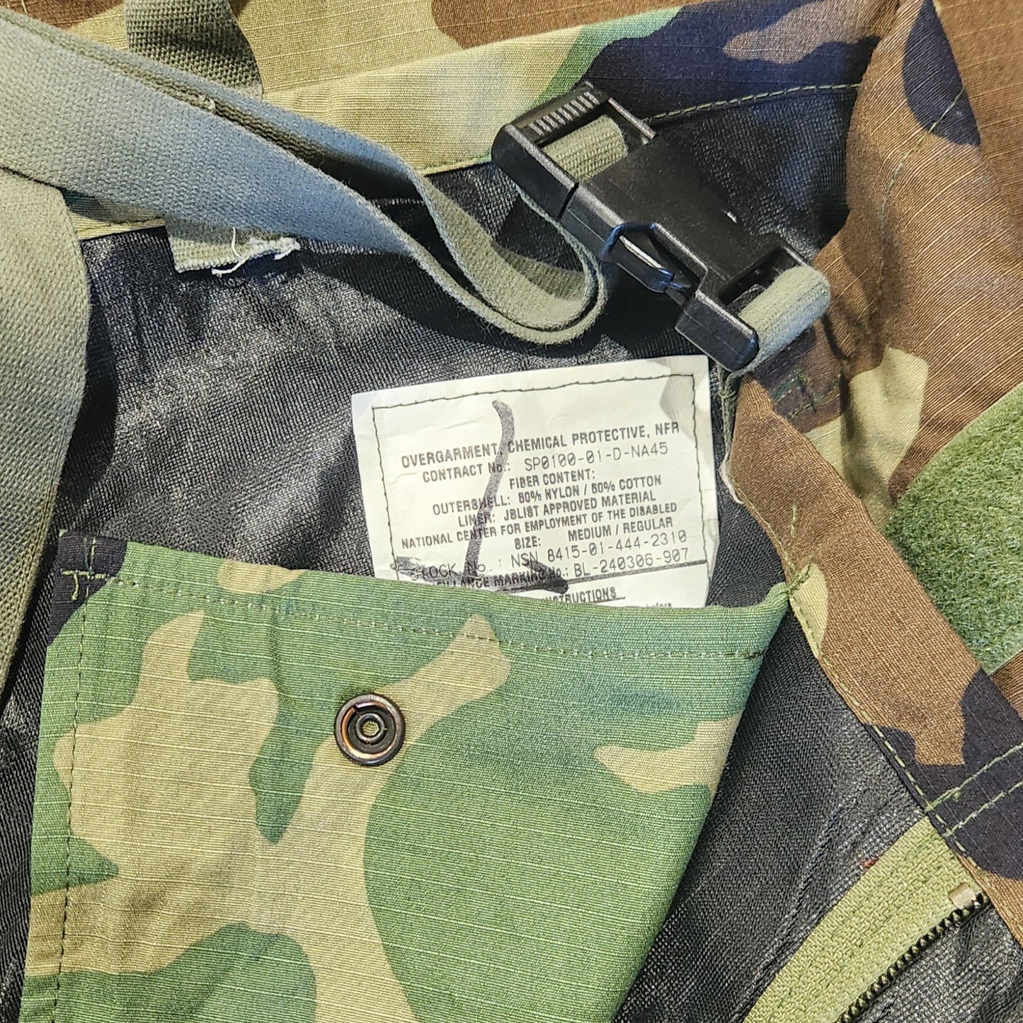 Camouflage bag with a visible brand label on a camouflage background
